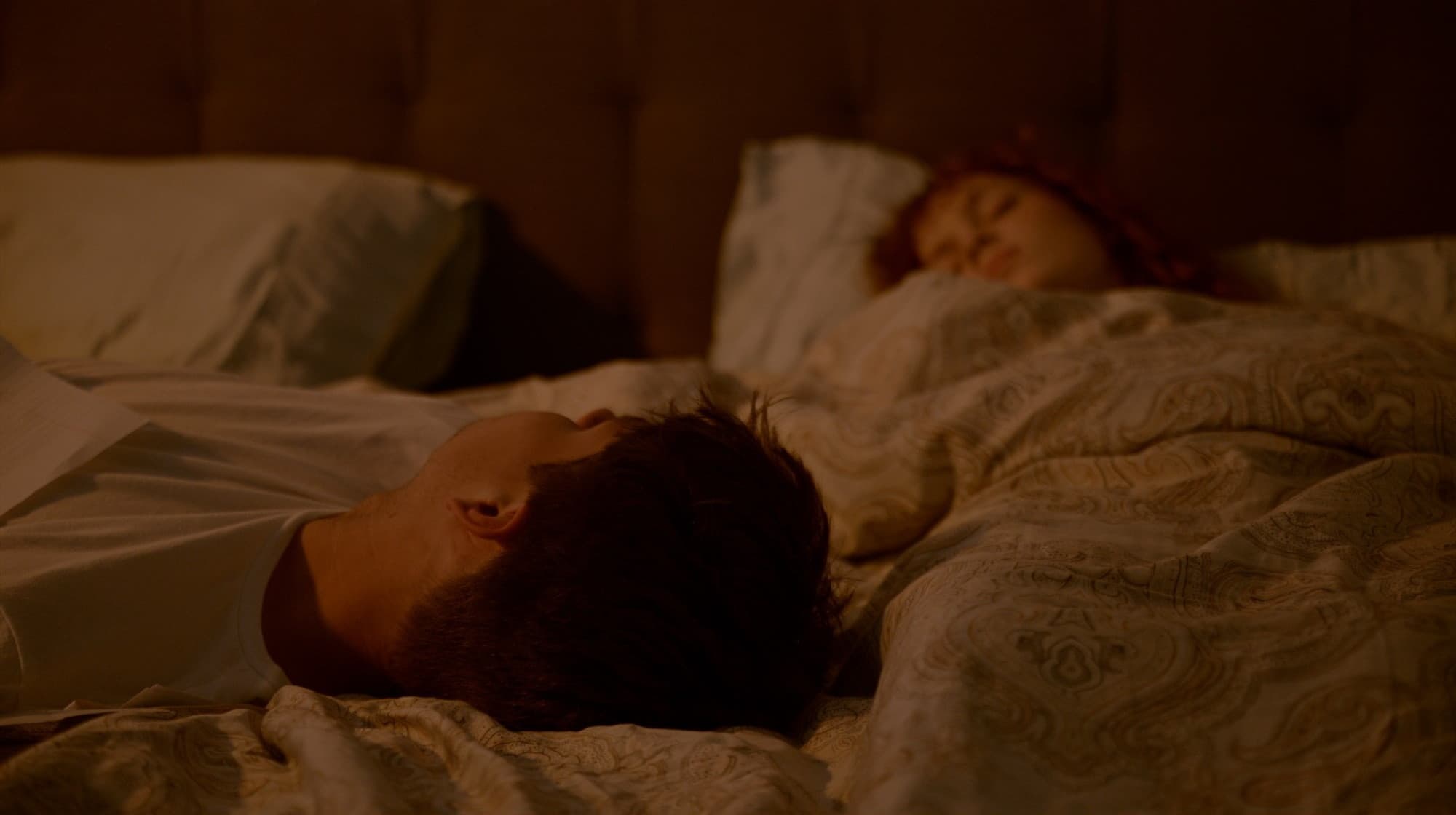Malachi and Ven asleep in bed — still from ‘Ven