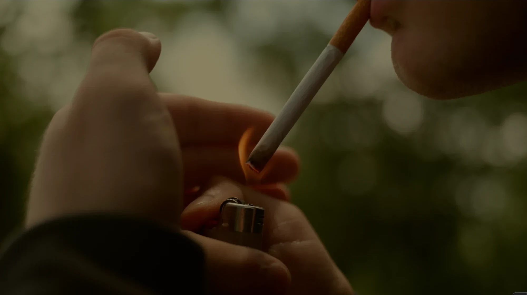 Lighting a cigarette — still from ‘Ven